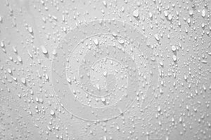 Blurred many water droplets on white bathroom wall