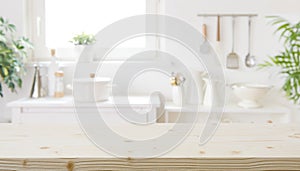 Blurred modern kitchen furniture interior with wooden table in front