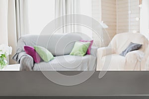 Blurred modern living room interior with chair, soft divan. Abstract background for design