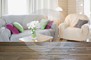 Blurred modern living room interior in rustic style with chair, soft divan. Abstract background for design.