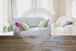 Blurred modern living room interior in rustic style with chair, soft divan. Abstract background for design.