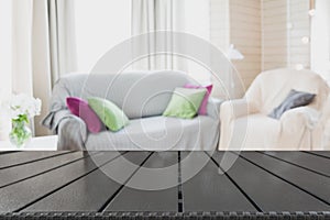 Blurred modern living room interior in rustic style with chair, soft divan. Abstract background for design.