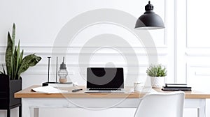 Blurred modern workplace with laptop, coffee cup and other items on wooden table