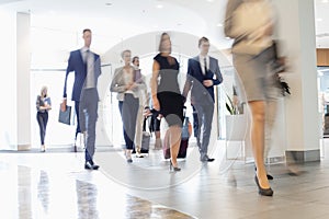 Blurred motion of business people walking at convention center