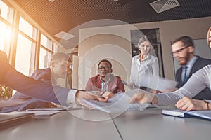 Blurred motion businesspeople working with boss sitting in background at office