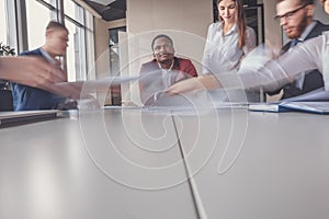 Blurred motion businesspeople working with boss sitting in background at office