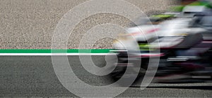 Blurred motion of motorcycle competing in racing circuit