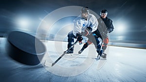 Blurred Motion Shot with 3D Flying Puck. Two Professional Ice Hockey Players on Arena From Different