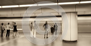 Blurred movement of people inside a subway station. Business and travel concept