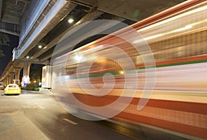 Blurred moving bus on the city road at night time background