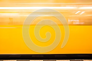 Blurred moving yellow train
