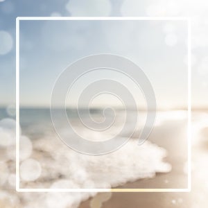Blurred nature background at the beach with lens flare and frame for copy space