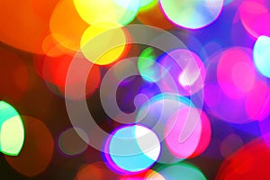 Blurred neon disco light dots pattern. Multi-coloured spotty background for design