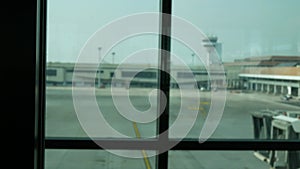 blurred out of focus View through window of the airport terminal in daytime to the airplane parking area