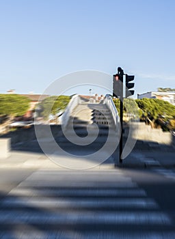 Blurred pedestrian crossroad with red semaphore