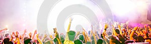 Blurred people dancing and having fun in summer festival party outdoor - Crowd with hands up celebrating fest concert event -