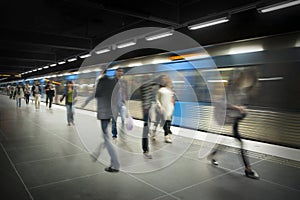 Blurred people on subway platform