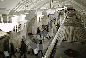 Blurred people on subway platform.