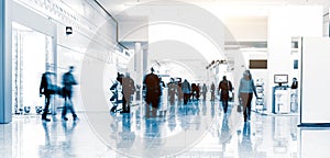 Blurred people walking in a trade fair hall