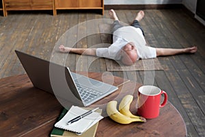 Blurred phot of senior caucasian man lying in Shavasana pose