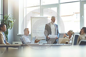 Blurred photo of a business people having a meeting in the modern office, working together