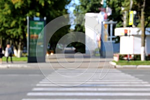 Blurred photo of a pedestrian crossing on a morning sunny day