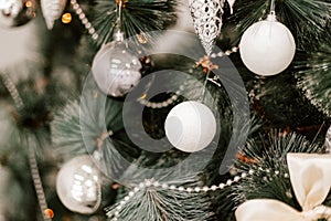 Blurred picture of christmas tree with lights and spruce branch. Defocused new year background with space for text
