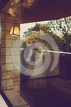 A blurred picture of a wedding couple standing on the balcony