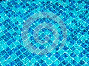 Blurred pool background. Blurry on top view of empty of blue mosaic tiles grid pattern in swimming pool.