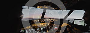 blurred professionals piloting airplane in evening