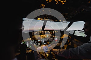 blurred professionals piloting airplane in evening