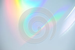 Blurred rainbow light refraction texture on white wall