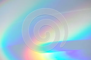 Blurred rainbow light refraction texture on white wall