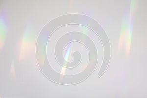 Blurred rainbow light refraction texture on white wall