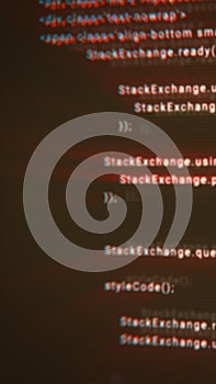 Blurred red-blue distorted code lines displayed on a dark screen, creating a glitchy digital programming aesthetic