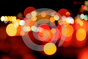 Blurred red and orange bokeh background. Blur abstract background of urban light. Warm light with beautiful pattern of round bokeh