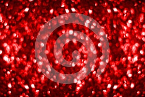 Blurred red shiny glitter bokeh background, defocused dark red shimmer backdrop design, bright red shining round bubbles blur