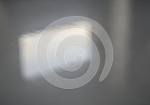 Blurred reflection of a rectangular light source on a smooth, glossy