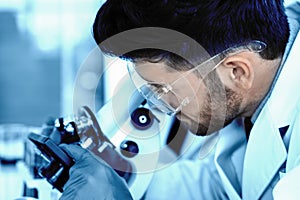 Blurred scient background of scientist reseacher using microscope in laboratory