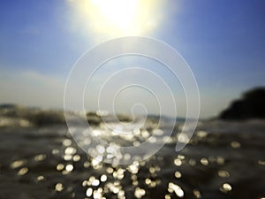 Blurred sea wave against sun