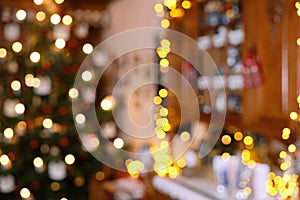 Blurred Section of Living Room Christmas Decoration with Christmas Tree and Lighted Cupboard