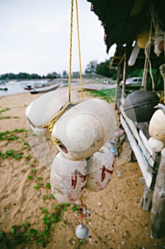 Blurred and selective focus image of hanging white dirty fish buoy