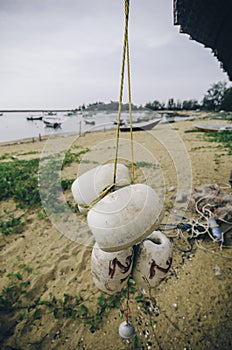 Blurred and selective focus image of hanging white dirty fish net buoy