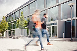 Blurred silhouette of students being busy on university campus