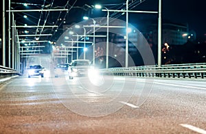 Blurred silhouettes of cars at night on the city streets