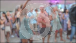 Blurred silhouettes of dancing people at a street disco or concert