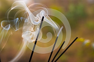 Blurred smokes of incense in temple