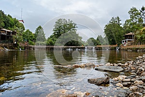 Blurred stones under water of Alva river in Coja river beach with stone walls and small waterfalls, Arganil PORTUGAL photo