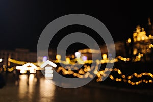 Blurred stylish christmas golden illumination and Christmas tree. Krakow, Poland, Main Square and Cloth Hall in the