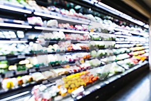 Blurred supermarket aisle shelves chilled fruit and vegetable zone